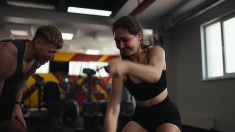 woman working out with a personal trainer at the gym