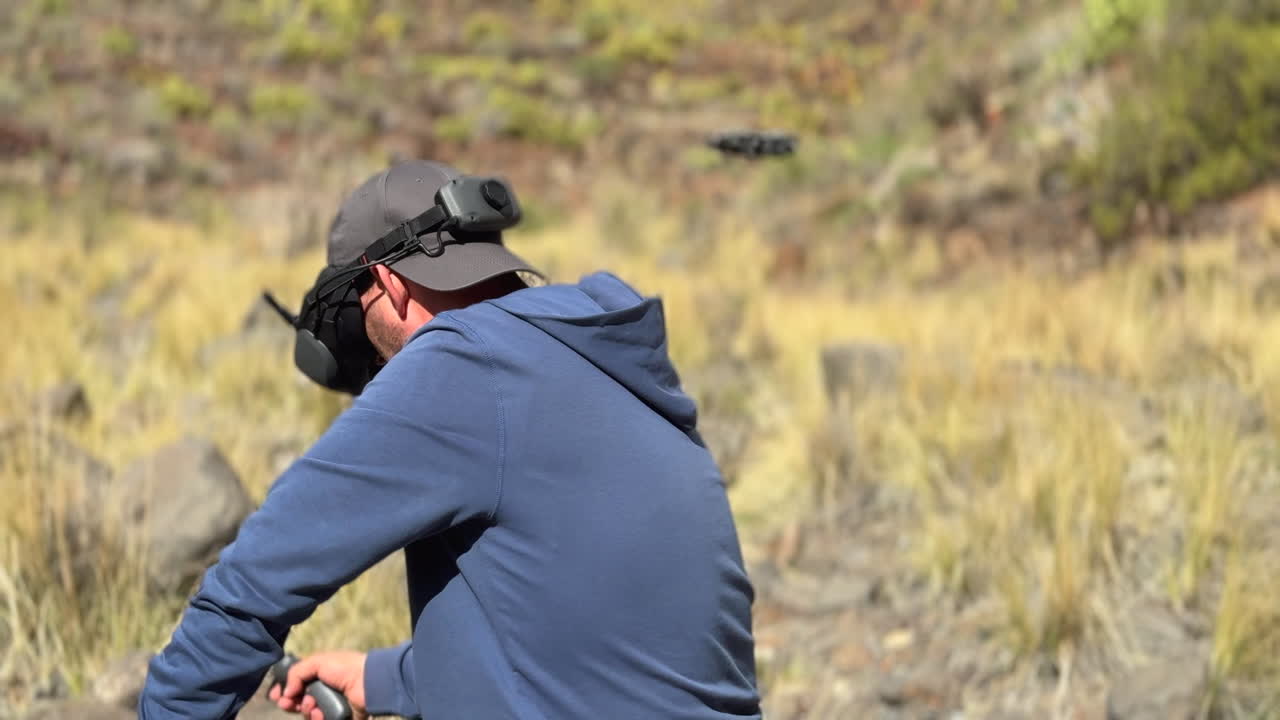 Man operating a first person view drone using remote controller in nature
