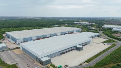 cinematic drone aerial close up view of warehouse distribution park with freight loading bays in kettering england united kingdom