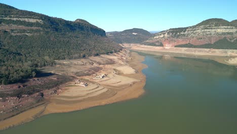 Drone-flight-in-a-beautiful-natural-park-in-Spain,-Europe-Sau-swamp-dike-in-Catalonia,-Spain,-intense-drought-in-2024