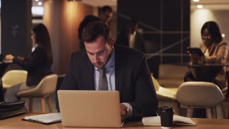 a young businessman working on a laptop