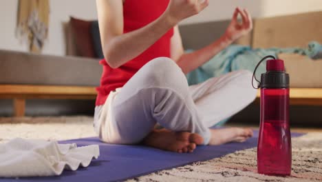 caucasian non-binary transgender woman practicing yoga, meditating