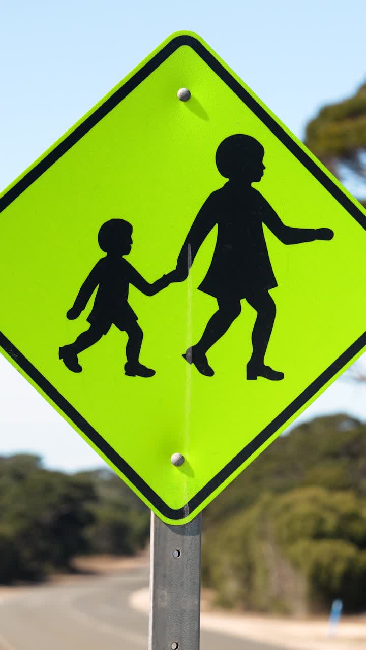 Vertical close-up of pedestrian crossing sign warning drivers of children, Australia