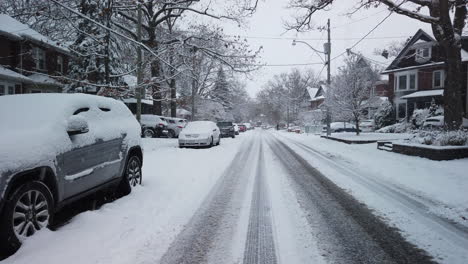 wide establishing shot of snowfall on a residential street in toronto