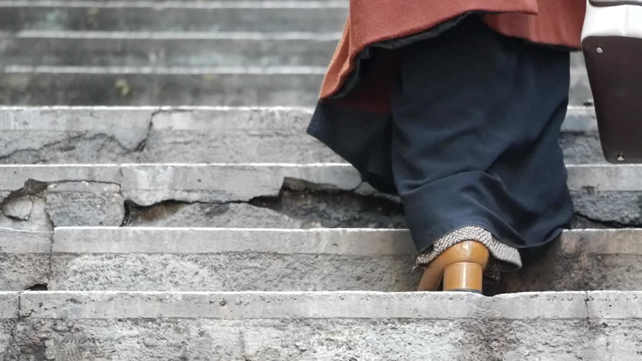 Woman walking up old stone stairs