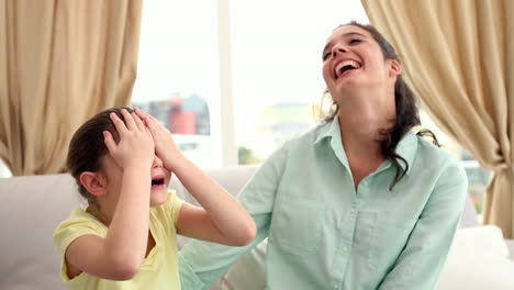 happy mother and daughter on the couch