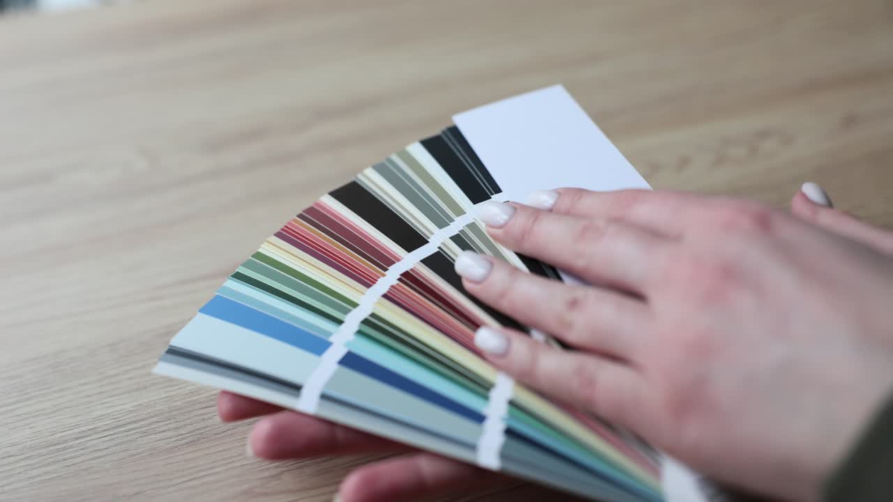 Close-up of a hand holding a color palette