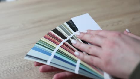 close-up of a hand holding a color palette