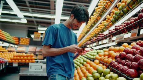 man shopping for fruits in a grocery store