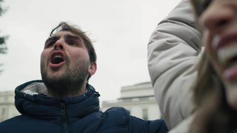 Close-up-of-group-of-young-caucasian-people-manifesting-against-conflict-in-Ukraine.