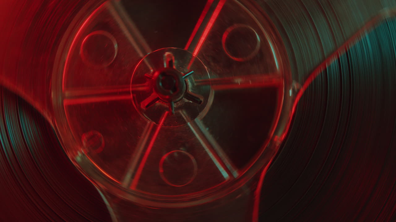Rotating Reels of Retro Tape Recorder in Red and Blue Light
