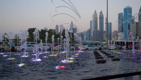 dubai fountain at dusk with city skyline