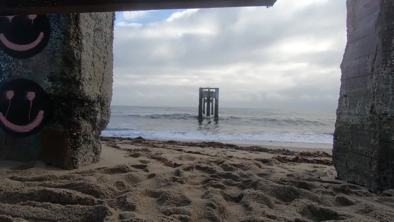 Swing attached to an abandoned pier on the beach