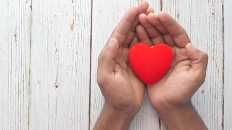 hands holding a red heart