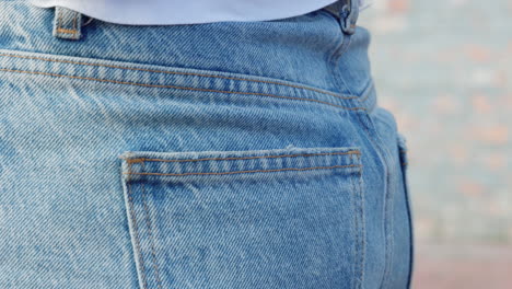 woman with phone in back pocket of jeans