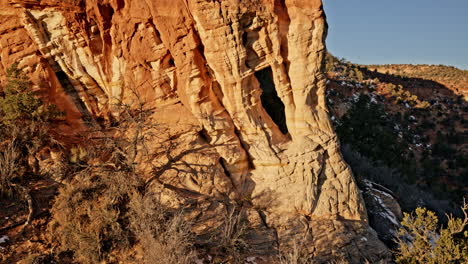 drone glides over a spectacular rock arch near kanab, utah, as the first light of day breaks.