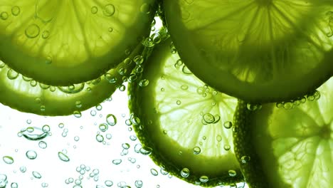 lime slices in water with bubbles