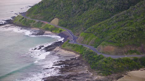 Car-driving-along-the-great-ocean-road,-aerial-view
