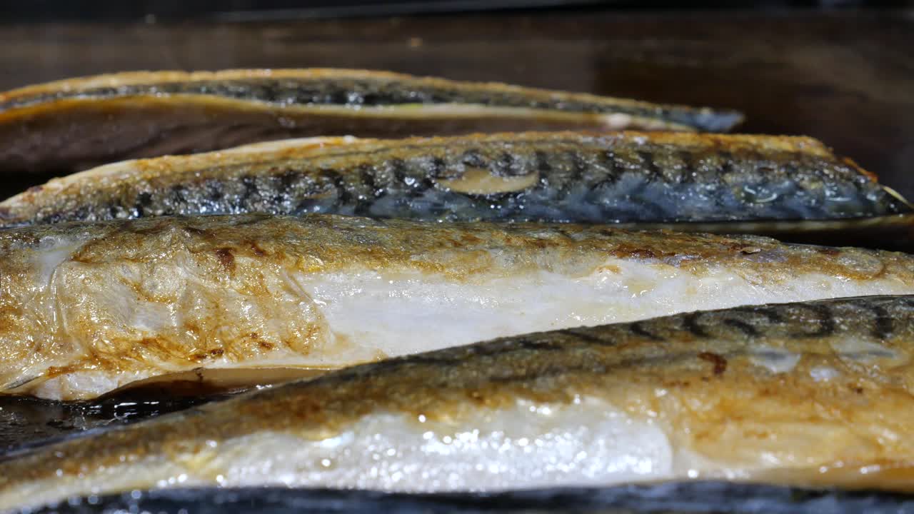 Fish cooking on a griddle