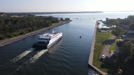 forward track behind the lake express ferry as it travels through the muskegon channel from milwaukee