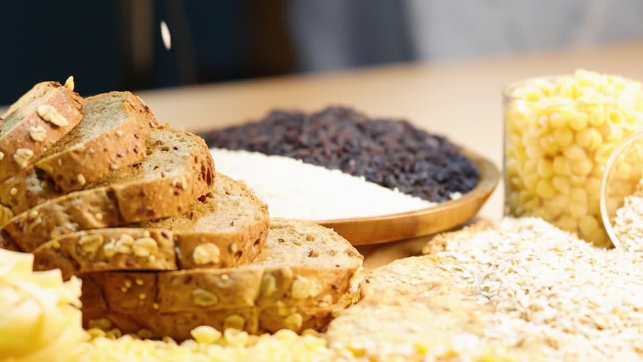 Sliced whole wheat bread and grains with oats falling, set in a bright kitchen environment