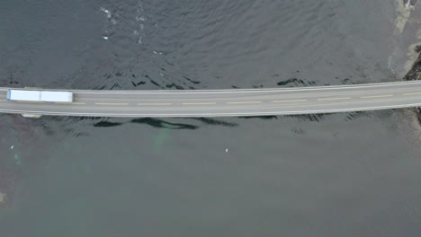 truck crossing storseisund through storseisundet bridge on the atlantic road in averoy, norway