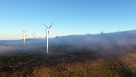 drone aerial footage of low lying cloud in a field with wind turbines in madeira, portugal
