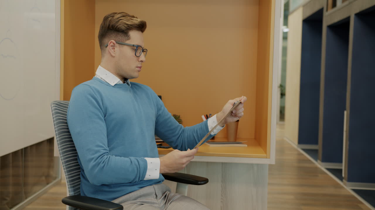 Businessman in Office with Clipboard