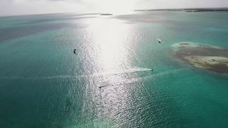 sunset two riders kiteboard cross bluewater sea, aerial view los roques