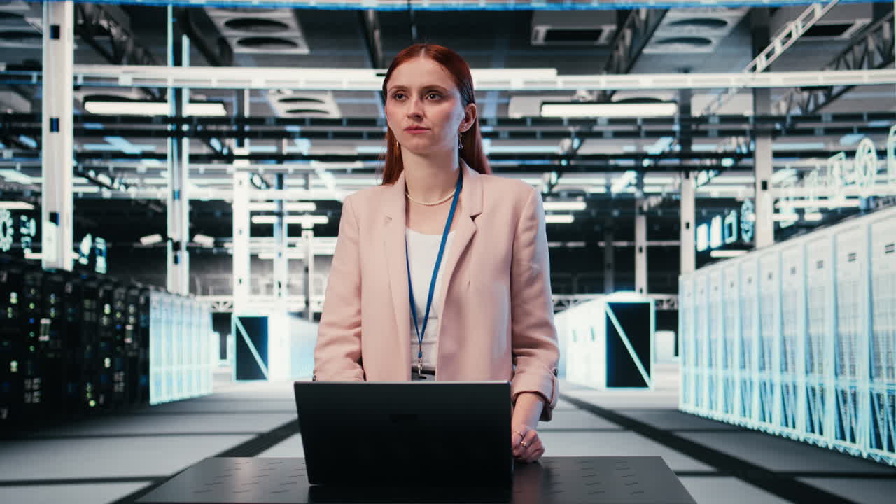 Female IT Professional Working on Laptop in Modern Data Center