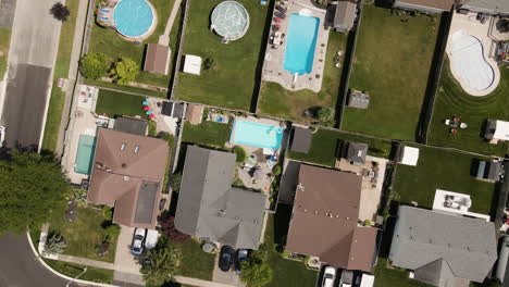 descend aerial top down shot of luxury residential area with swimming pools in garden - welland town in ontario,canada