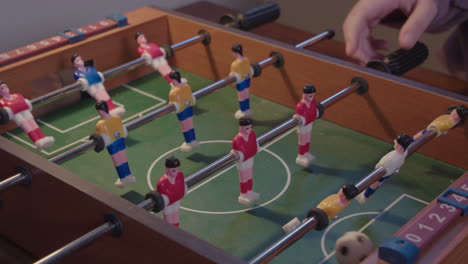 children playing miniature table football game