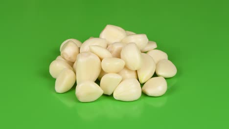 garlic on green background. side view. loop motion. rotation 360.