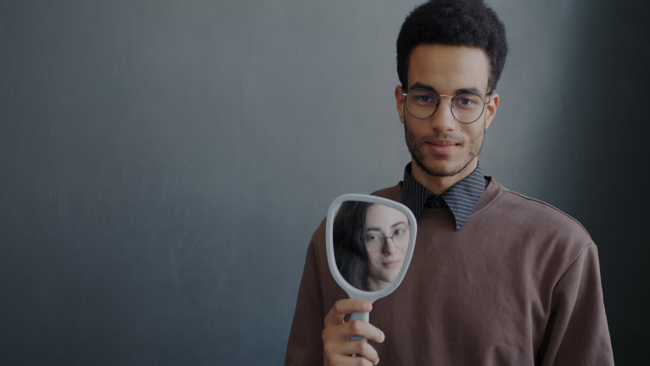 Man Holding Mirror with Reflection of Woman