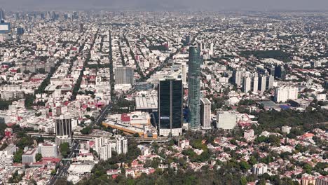 aerial footage capturing southern skyline of mexico city, showcasing its towering skyscrapers