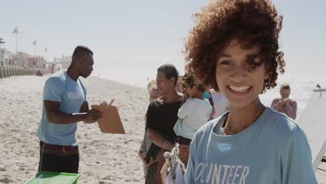 female volunteer looking at camera on the beach 4k