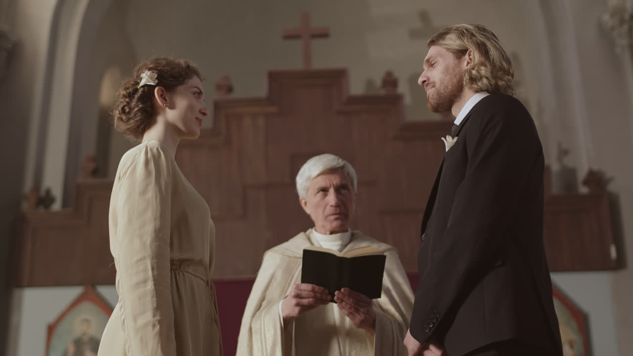 Young Couple Having Wedding Ceremony in Christian Church