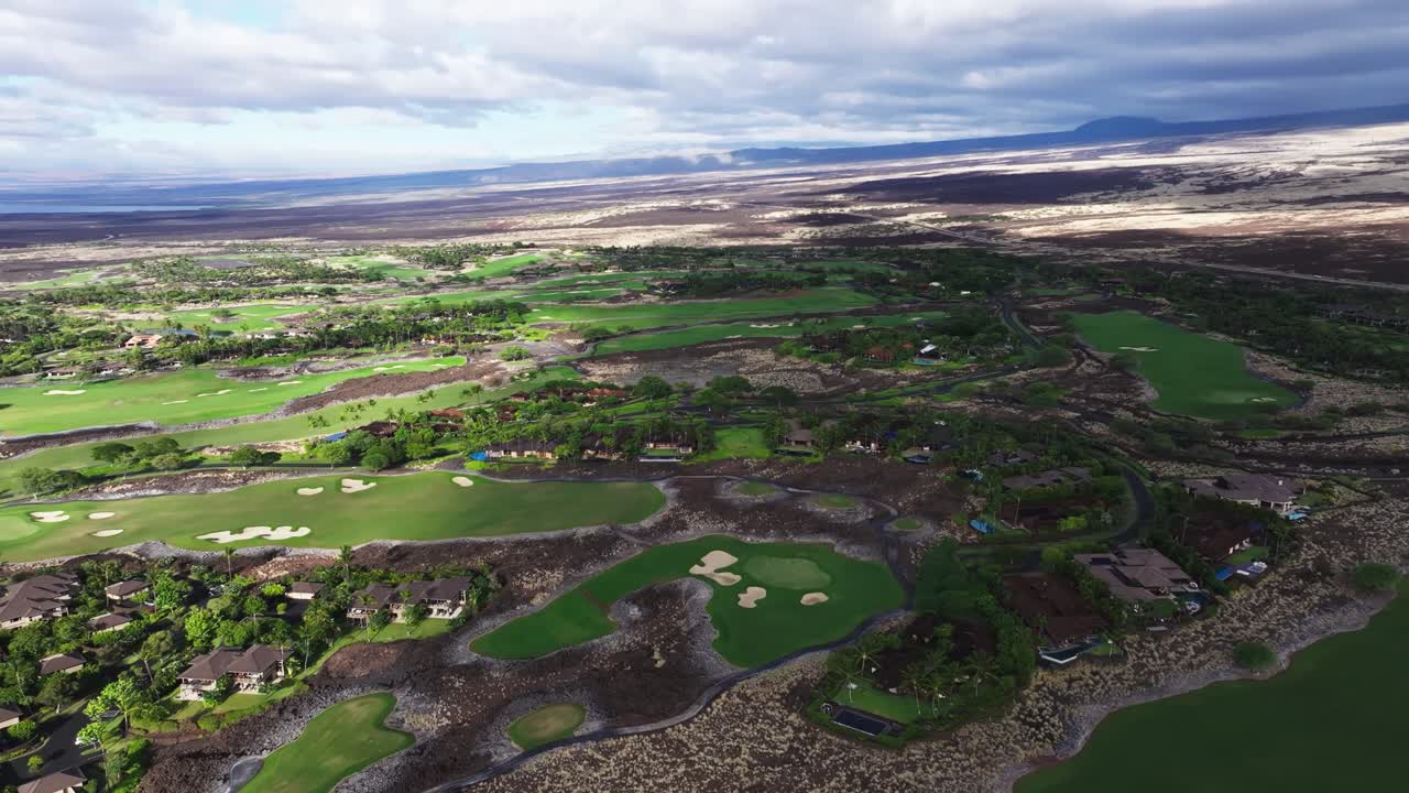 Exploring the Lush Green Landscapes of a Golf Course in Hawaii Amidst Volcanic Scenery and Dramatic Clouds