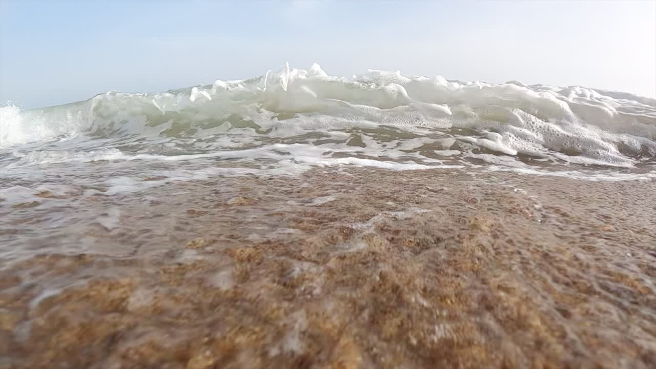 Waves hitting the shore on the beach