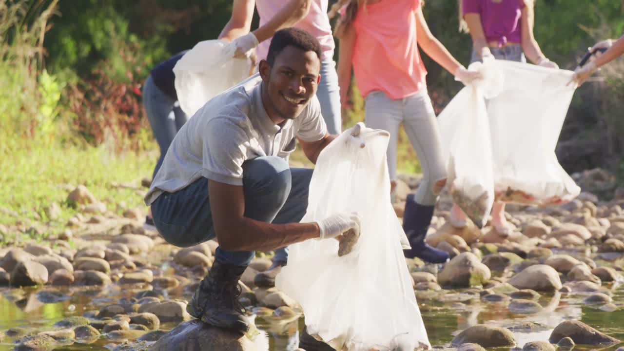 Mid adults volunteering during river clean-up day