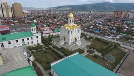 aerial drone shot of a russian church with gold plated roof in mongolia