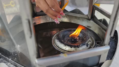 oil lamp burning in a metal lantern