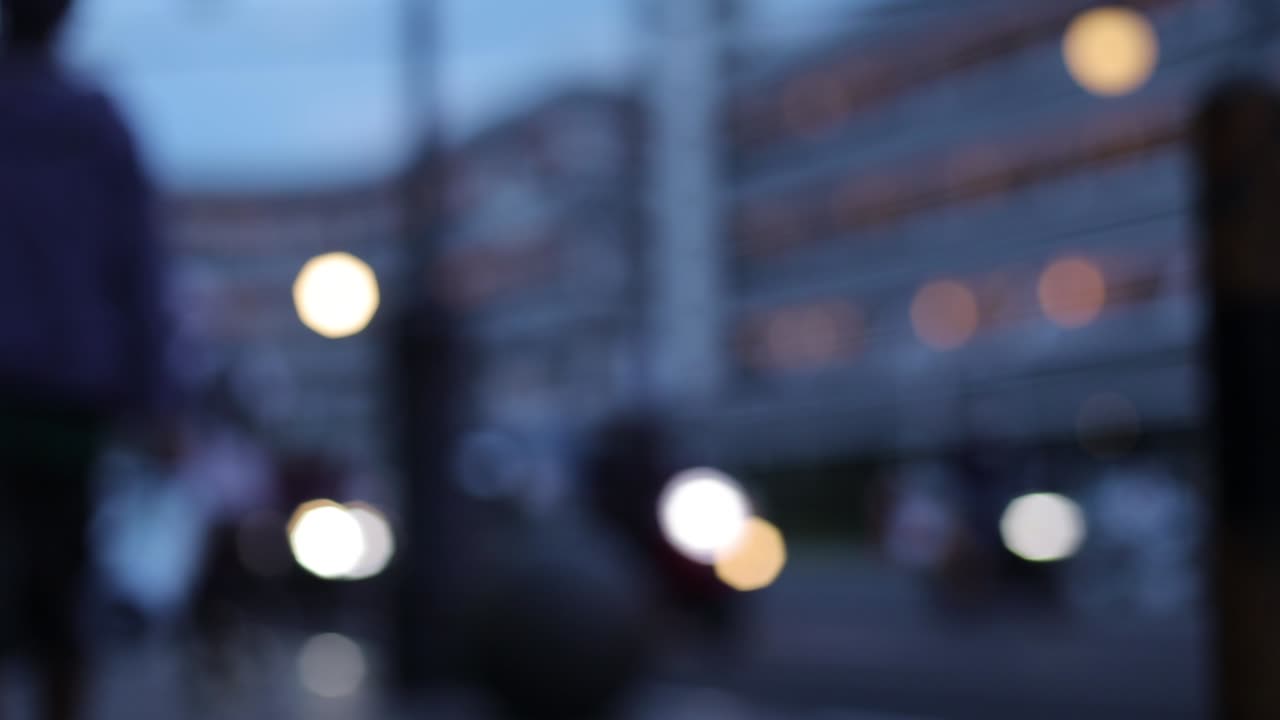 Blurry footage of street and car light passing on the dark afternoon