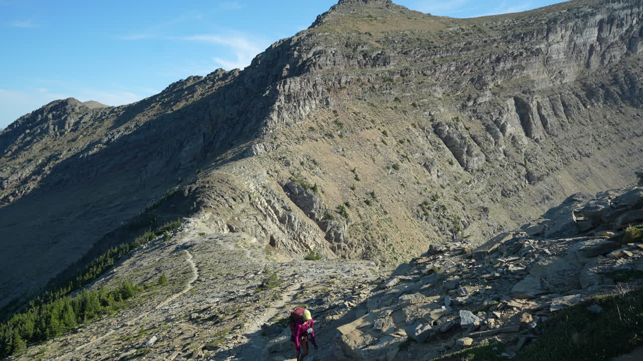 joven excursionista en el empinado sendero de senderismo en el parque nacional glacier, montana, estados unidos
