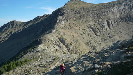 young female hiker on steep hiking trail in glacier national park, montana usa