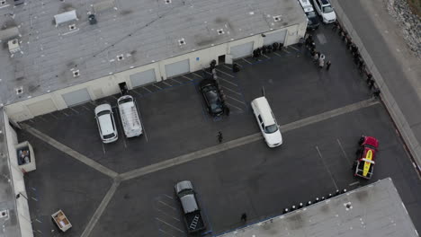 aerial drone spirals upwards outside of a funeral