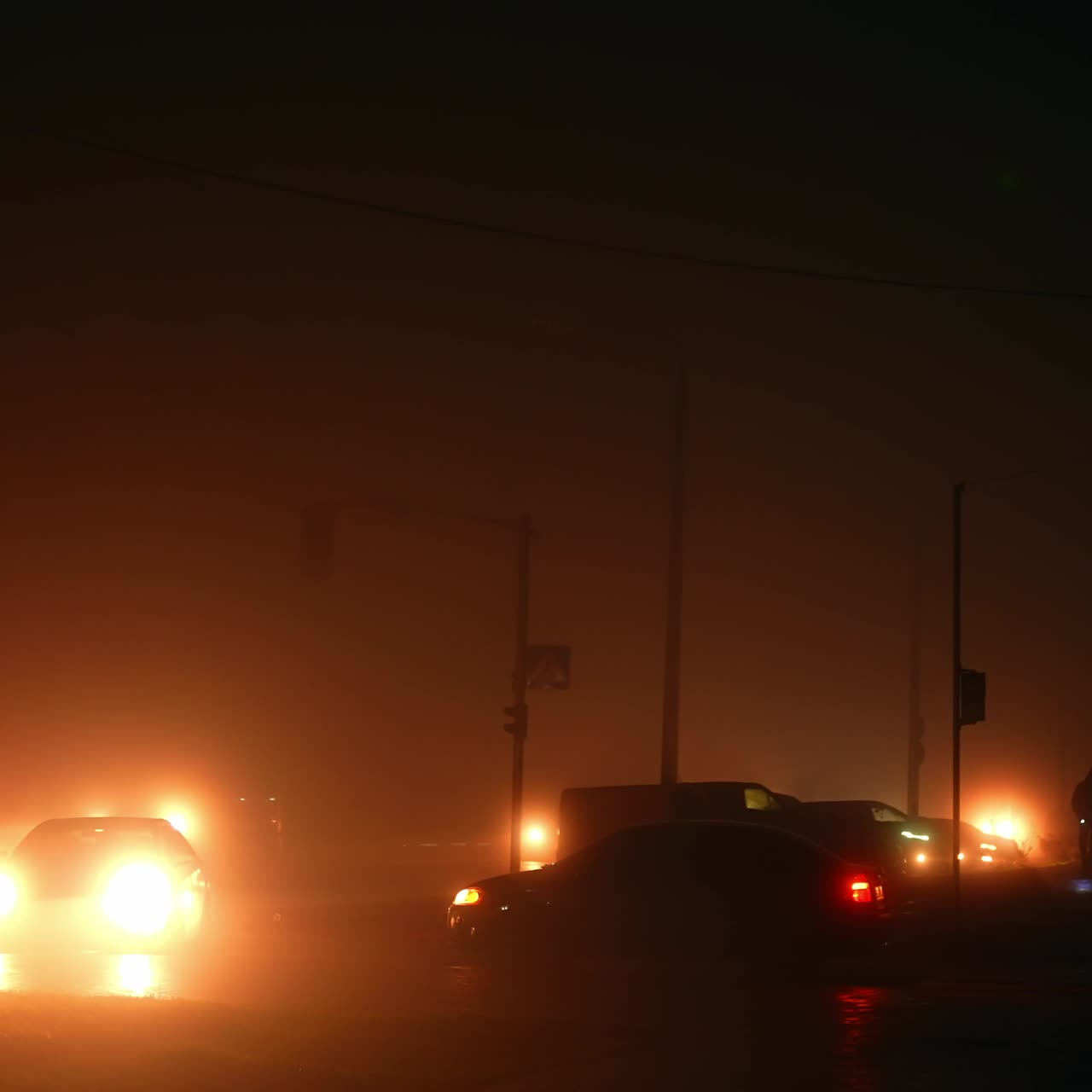 Car lights lighting the dark streets of the city when there's no power. Night period time during blackout