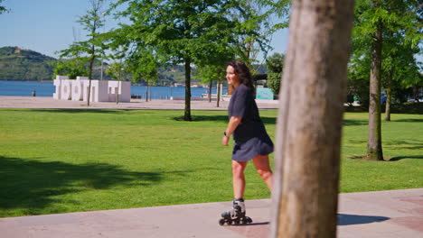 woman rollerblading in a park by the river