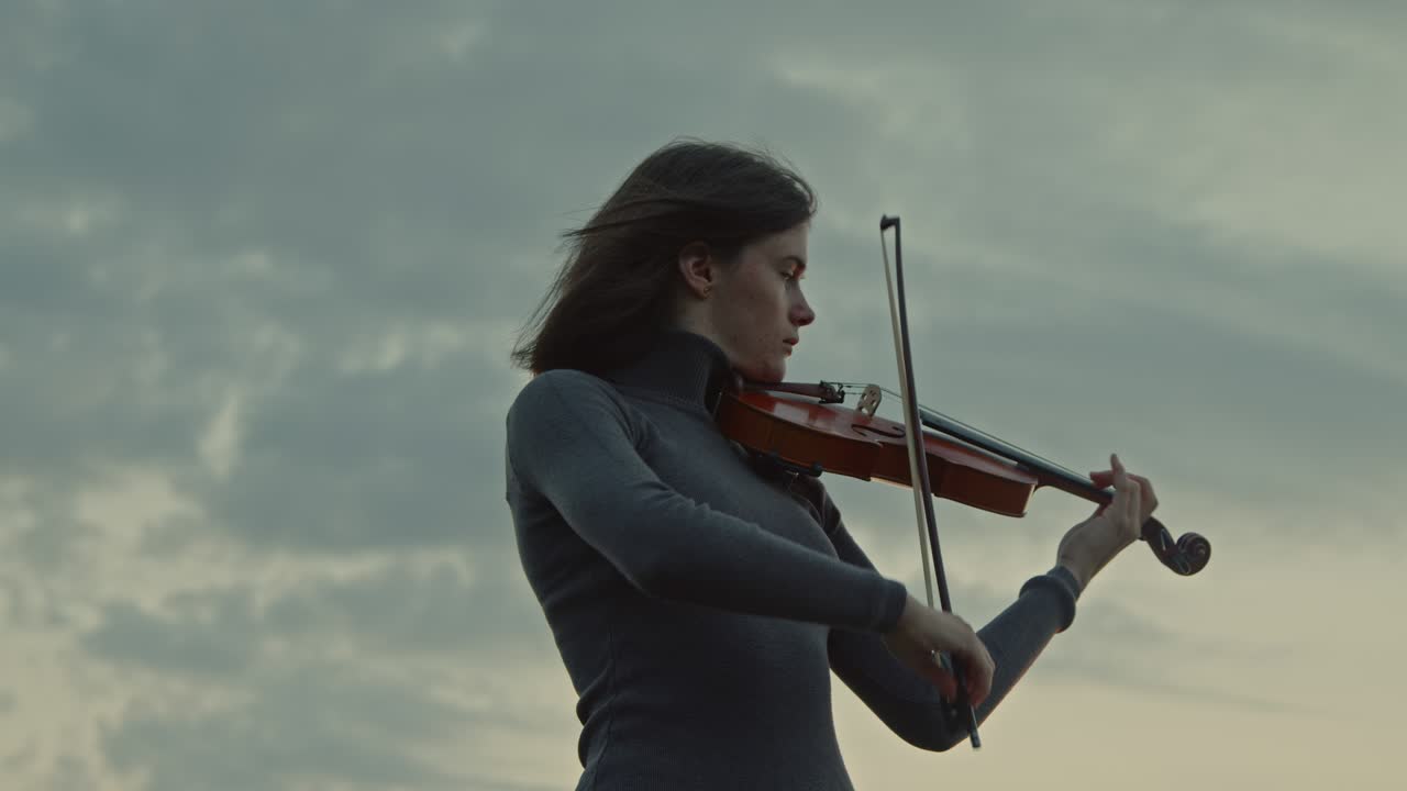 Lady Is Playing Violin In the Morning Outside