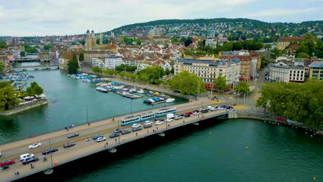 4k drone video of traffic on the quaibrücke bridge over the limmat river in downtown zurich, switzerland (high speed)
